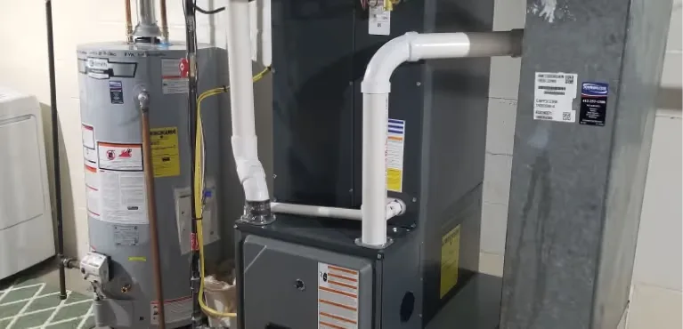High-efficiency furnace installed with new white PVC venting