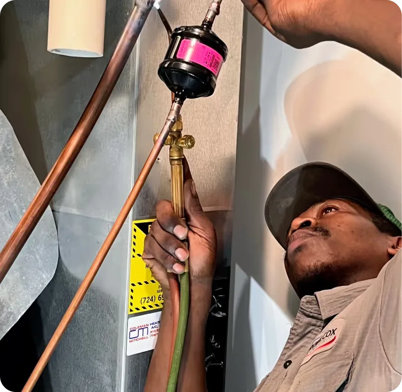 Technician soldering copper pipe for a gas line connection