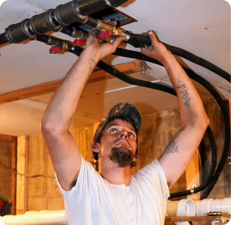 Technician working overhead on refrigerant lines