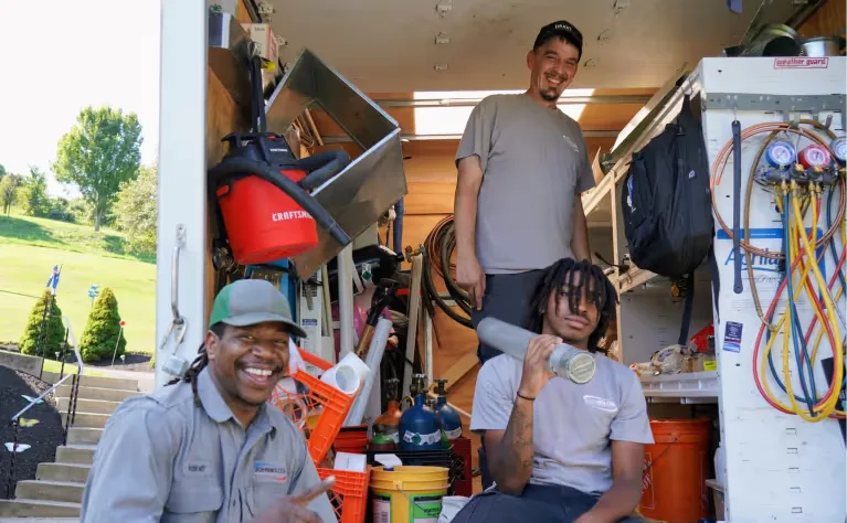 Sureway crew together in the shop with tools and equipment